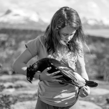 Girl with dead black grouse